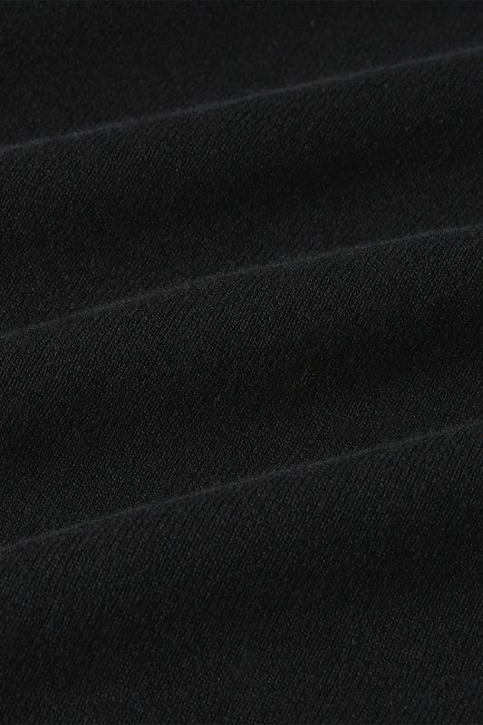 Detailaufnahme des schwarzen Bio-Baumwollstricks vom Ute Cardi Club